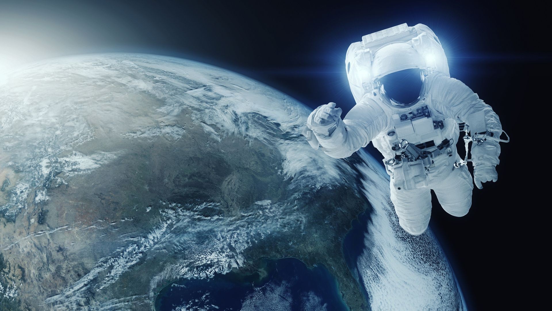 Astronaut in open space. Earth planet background. Elements of this image furnished by NASA